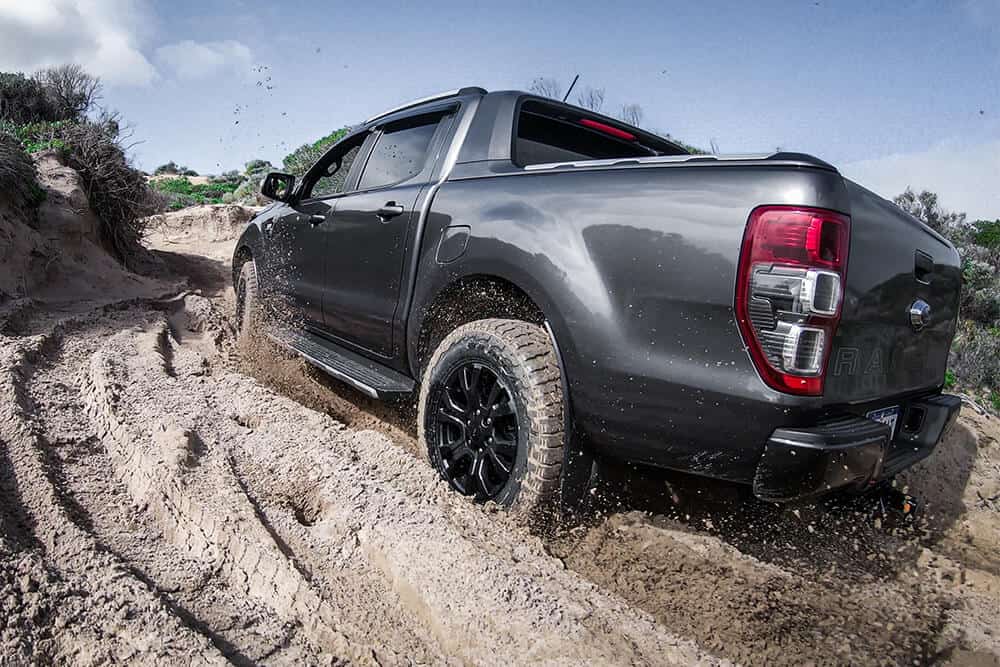 Image of a truck driving through a mud puddle
