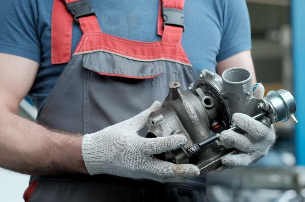 Image of a person holding a turbocharger