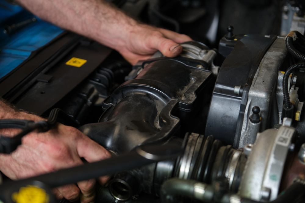 Image of a person working on a car's turbocharger intercooler | T1 turbos