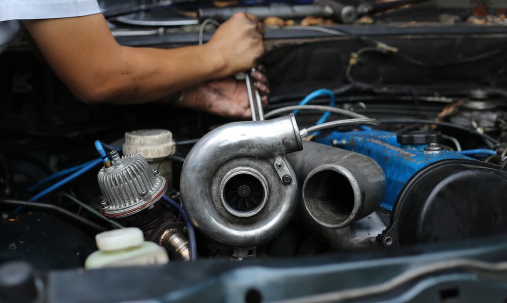 Image of a person working in a car turbocharger performance